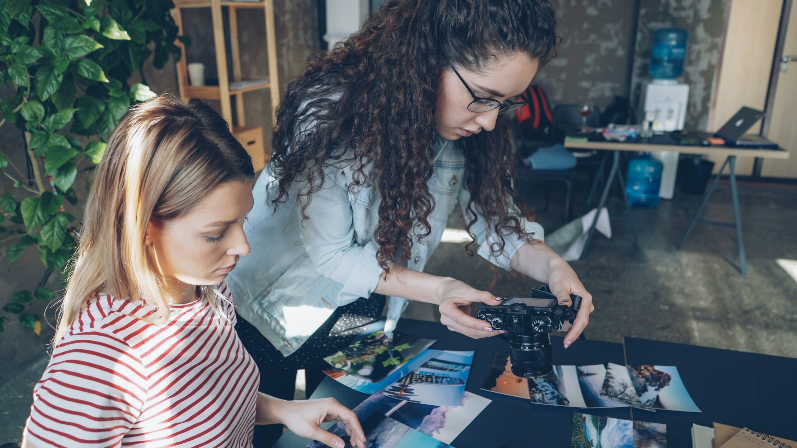 woman taking picture of busy crowded desk